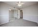 Bedroom with carpet, ceiling fan, and sliding mirror closet with easy access to storage at 4613 E Douglas Ave, Gilbert, AZ 85234