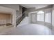 Bright foyer with tile flooring, a staircase, and an arched window above the entry door at 4613 E Douglas Ave, Gilbert, AZ 85234