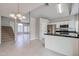 Open-concept kitchen with stainless steel appliances, white cabinets, and breakfast bar at 4613 E Douglas Ave, Gilbert, AZ 85234