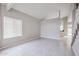 Open living room space with tile flooring, large windows, and neutral wall colors at 4613 E Douglas Ave, Gilbert, AZ 85234