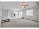 Bright living room with carpet, stairs, and an open view of the eat-in kitchen at 4613 E Douglas Ave, Gilbert, AZ 85234