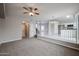 Open-concept living room with stairs, carpet, and ceiling fan at 4613 E Douglas Ave, Gilbert, AZ 85234