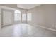 Inviting front room with tile flooring, a white door, and ample natural light from the windows at 4613 E Douglas Ave, Gilbert, AZ 85234