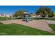 This park offers a playground and picnic benches and is surrounded by lush green grass and mature trees at 4613 E Douglas Ave, Gilbert, AZ 85234