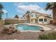 Backyard pool with desert landscaping, large rocks, and ample entertaining space at 4613 E Douglas Ave, Gilbert, AZ 85234