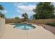 Backyard pool with rock waterfall feature, desert landscaping, and space for entertaining at 4613 E Douglas Ave, Gilbert, AZ 85234