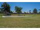 This park offers swings and is surrounded by lush green grass and mature trees at 4613 E Douglas Ave, Gilbert, AZ 85234