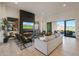 Bright living space showcasing a contemporary fireplace and seamless indoor-outdoor flow to the patio at 530 E Woburn Ln, Phoenix, AZ 85085