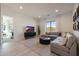 Living room featuring a gray sectional sofa, black media console, and view of the backyard at 530 E Woburn Ln, Phoenix, AZ 85085