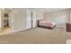 Large main bedroom with seating area, plush carpet, and ensuite bathroom at 6409 S 49Th Dr, Laveen, AZ 85339