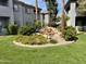 Lush community landscaping includes mature trees, bushes, and a decorative pond at 7401 W Arrowhead Clubhouse W Dr # 1015, Glendale, AZ 85308