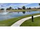 Scenic walking path in the community by a tranquil pond with a water feature at 7401 W Arrowhead Clubhouse W Dr # 1015, Glendale, AZ 85308