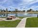 Community pond with water fountain, seating, and desert landscaping at 7401 W Arrowhead Clubhouse W Dr # 1015, Glendale, AZ 85308