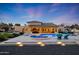 Backyard featuring a large pool, lounge chairs, and outdoor bar area, illuminated at twilight at 7481 E Camino Santo --, Scottsdale, AZ 85260