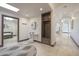 Bright foyer with tile flooring, large mirror, and coat rack creates an inviting entry at 7481 E Camino Santo --, Scottsdale, AZ 85260