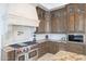 Close-up of a kitchen's stainless steel stove, granite countertops, and white tile backsplash at 7481 E Camino Santo --, Scottsdale, AZ 85260