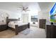 Spacious main bedroom featuring a ceiling fan, a window seat, and a comfortable bed with decorative pillows at 7481 E Camino Santo --, Scottsdale, AZ 85260