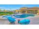 Backyard pool with adjacent spa, lounge chairs, and tennis court at 7481 E Camino Santo --, Scottsdale, AZ 85260