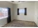 Cozy bedroom with neutral carpet, two windows with curtains, and a ceiling fan for comfort at 7636 E Coronado Rd, Mesa, AZ 85207