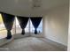 Bedroom featuring three windows with dark curtains and a ceiling fan at 7636 E Coronado Rd, Mesa, AZ 85207