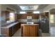 Kitchen showcasing wood cabinets, stainless steel refrigerator, and natural light at 7636 E Coronado Rd, Mesa, AZ 85207