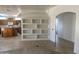 Open-concept living room featuring built-in shelving connecting to the kitchen at 7636 E Coronado Rd, Mesa, AZ 85207