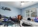 Bright bedroom features a ceiling fan and a large window at 8576 W Mclellan Rd, Glendale, AZ 85305