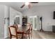 Open-concept dining area with vaulted ceiling, wood-look floors, slider to backyard, and neutral paint at 8576 W Mclellan Rd, Glendale, AZ 85305