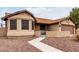 Exterior of charming single-story home with light brown stucco, brown roof, and landscaped yard at 8576 W Mclellan Rd, Glendale, AZ 85305