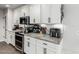 Bright kitchen featuring white cabinets, gray countertops, stainless steel appliances, and tiled backsplash at 8576 W Mclellan Rd, Glendale, AZ 85305