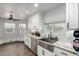 Bright kitchen featuring white cabinets, granite countertops, stainless steel sink, and stainless steel appliances at 8576 W Mclellan Rd, Glendale, AZ 85305