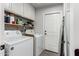 Bright laundry room features a washer, dryer, and ample storage space at 8576 W Mclellan Rd, Glendale, AZ 85305