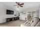 Cozy living room with vaulted ceiling, carpet, ceiling fan, slider to backyard, and neutral paint at 8576 W Mclellan Rd, Glendale, AZ 85305