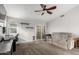 Comfortable living room featuring vaulted ceiling, carpet, ceiling fan, slider to backyard, and neutral paint at 8576 W Mclellan Rd, Glendale, AZ 85305