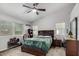 Spacious main bedroom with vaulted ceiling, ceiling fan, windows, carpet, and neutral paint at 8576 W Mclellan Rd, Glendale, AZ 85305