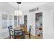 Bright dining area featuring a round table, modern chandelier, and convenient pantry storage at 8781 S Mill Ave, Tempe, AZ 85284