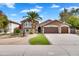 Charming two-story home with a desert landscape, water fountain, and three-car garage at 8781 S Mill Ave, Tempe, AZ 85284