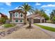 Charming two-story home with a desert landscape, water fountain, and three-car garage at 8781 S Mill Ave, Tempe, AZ 85284