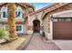 Inviting home with an arched doorway, stone accents, and a manicured lawn at 8781 S Mill Ave, Tempe, AZ 85284