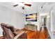 This living room features reclining chair, a ceiling fan, a TV and a hallway at 8781 S Mill Ave, Tempe, AZ 85284