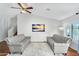 Bright living room features a ceiling fan and two gray couches, creating a cozy atmosphere at 8781 S Mill Ave, Tempe, AZ 85284