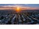 A neighborhood view from above as the sun sets on the horizon, highlighting the beautiful mountain views at 9523 W Sandstone Dr, Sun City, AZ 85351