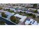 Aerial view of a residential neighborhood featuring well-kept homes, mature trees, and manicured lawns at 9523 W Sandstone Dr, Sun City, AZ 85351