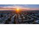 Stunning aerial view of a residential area at sunset, capturing the warm hues and mountain backdrop at 9523 W Sandstone Dr, Sun City, AZ 85351