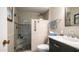 Bathroom featuring a walk-in shower with grab bar and seat with a dark vanity and light countertop at 9523 W Sandstone Dr, Sun City, AZ 85351