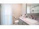 Bathroom featuring a soft color palette, light grey cabinets, and white curtain and fixtures at 9523 W Sandstone Dr, Sun City, AZ 85351