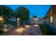 Charming courtyard with decorative brickwork, exterior lighting, and lush greenery at 9523 W Sandstone Dr, Sun City, AZ 85351