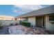 Inviting front entrance with a tiled courtyard, manicured landscaping, and charming details at 9523 W Sandstone Dr, Sun City, AZ 85351