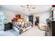 Bright main bedroom featuring a ceiling fan, carpeted floor and access to an office space at 9523 W Sandstone Dr, Sun City, AZ 85351