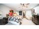 Bright main bedroom featuring a ceiling fan, carpeted floor and access to an office space at 9523 W Sandstone Dr, Sun City, AZ 85351